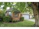 Brick house with mature tree, lush lawn, and neatly trimmed shrubs at 7013 Ringtail Ct, Indianapolis, IN 46254