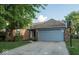 Charming single-story brick home with a well-maintained lawn and an attached two-car garage at 7013 Ringtail Ct, Indianapolis, IN 46254