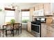 Bright eat-in kitchen features tile floors, updated appliances, and lots of light at 7013 Ringtail Ct, Indianapolis, IN 46254