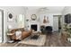 Cozy living room with a brick fireplace, wood floors, and a ceiling fan at 7013 Ringtail Ct, Indianapolis, IN 46254