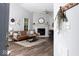 Bright living room with a fireplace, wood flooring, and modern decor at 7013 Ringtail Ct, Indianapolis, IN 46254
