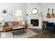 Sunlit living room with wood floors, stylish furniture, and a cozy fireplace at 7013 Ringtail Ct, Indianapolis, IN 46254
