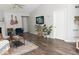 Spacious living room featuring light-filled windows, a fireplace, and wood floors at 7013 Ringtail Ct, Indianapolis, IN 46254