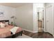 Cozy main bedroom with a calming color palette, wood floors, and an ensuite bathroom at 7013 Ringtail Ct, Indianapolis, IN 46254