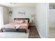 Relaxing main bedroom showcasing light walls, wood floors, and an ensuite bathroom at 7013 Ringtail Ct, Indianapolis, IN 46254