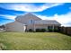 The backyard features a lush green lawn and the home's neutral-toned siding at 7136 Allegan Dr, Indianapolis, IN 46217