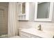 Charming bathroom featuring a vanity with marble countertop and subway tile backsplash at 7136 Allegan Dr, Indianapolis, IN 46217