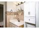 Cozy bathroom featuring a sink, toilet and tile work at 7136 Allegan Dr, Indianapolis, IN 46217
