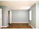 An empty bedroom with light blue walls, wood floors, and a closet is bright and airy at 7136 Allegan Dr, Indianapolis, IN 46217