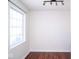 Bedroom featuring wood floors, a large window with natural light, and modern lighting at 7136 Allegan Dr, Indianapolis, IN 46217