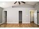 Primary bedroom featuring multiple doors and wood floors at 7136 Allegan Dr, Indianapolis, IN 46217