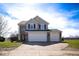 Charming two-story home featuring a spacious three-car garage and well-maintained front yard at 7136 Allegan Dr, Indianapolis, IN 46217