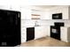 Modern kitchen with sleek black appliances and white cabinetry, creating a stylish culinary space at 7136 Allegan Dr, Indianapolis, IN 46217