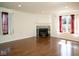 Spacious living room featuring a fireplace, hardwood floors, and bright natural light at 7136 Allegan Dr, Indianapolis, IN 46217