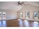 A spacious living room with a fan, wood floors, natural light, and access to a deck at 7136 Allegan Dr, Indianapolis, IN 46217
