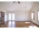 Large living room featuring French doors, a fan, and lots of natural light at 7136 Allegan Dr, Indianapolis, IN 46217
