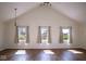 Bright living room featuring three windows, high ceilings, and hardwood floors at 7136 Allegan Dr, Indianapolis, IN 46217