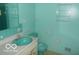 Aqua bathroom featuring toilet, sink, and towel racks at 7240 W Glendale Ln, Greenfield, IN 46140
