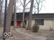 Charming brick home with a red front door and mature trees in a quiet neighborhood at 7240 W Glendale Ln, Greenfield, IN 46140