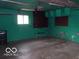 Garage with window, storage, and work area at 7240 W Glendale Ln, Greenfield, IN 46140