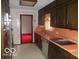 Cozy kitchen featuring functional layout, vintage appliances, and retro countertops and wallpaper at 7240 W Glendale Ln, Greenfield, IN 46140