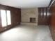 Spacious living room featuring a brick fireplace and large windows with lots of natural light at 7240 W Glendale Ln, Greenfield, IN 46140