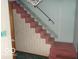 Carpeted staircase featuring handrail and chandelier at 7240 W Glendale Ln, Greenfield, IN 46140