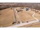 An aerial view displaying multiple estates with long driveways and a serene pond at 7260 N 225 W, Lebanon, IN 46052