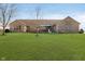Well-maintained brick home with a sprawling lawn and mature trees under a sunny sky at 7260 N 225 W, Lebanon, IN 46052