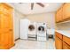 Bright laundry room features tile floors, wood cabinets, modern washer and dryer appliances at 7260 N 225 W, Lebanon, IN 46052