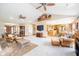 Spacious living room featuring vaulted ceilings, ceiling fans, and an open view to the kitchen at 7260 N 225 W, Lebanon, IN 46052