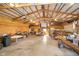 Large outbuilding interior with exposed beams and plywood walls, offering ample workspace and storage at 7260 N 225 W, Lebanon, IN 46052