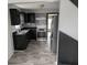 Modern kitchen with stainless steel appliances, gray flooring, and stylish backsplash at 730 Waldemere Ave, Indianapolis, IN 46241