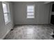 Bright living room featuring updated flooring, fresh paint, and windows at 730 Waldemere Ave, Indianapolis, IN 46241