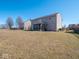 Spacious backyard featuring a screened porch, grassy area, and privacy fence for outdoor enjoyment at 7536 Shasta Dr, Indianapolis, IN 46217