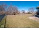 Large backyard with a playground set, grassy area, and a partial patio, perfect for outdoor activities at 7536 Shasta Dr, Indianapolis, IN 46217