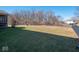Large backyard with a swing set and mature trees at 7536 Shasta Dr, Indianapolis, IN 46217