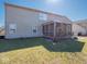 A large backyard featuring a screened porch, grassy area, and well-maintained lawn, great for outdoor living at 7536 Shasta Dr, Indianapolis, IN 46217