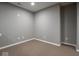 A spacious room with neutral-colored walls and carpeted flooring at 7536 Shasta Dr, Indianapolis, IN 46217