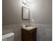 Bathroom featuring a sink, mirror, and toilet with tile flooring and neutral wall color at 7536 Shasta Dr, Indianapolis, IN 46217