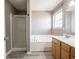 Bathroom with walk-in shower, tub, wood cabinets, and tile flooring at 7536 Shasta Dr, Indianapolis, IN 46217