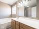 Bathroom featuring soaking tub, wooden vanity, and large mirror at 7536 Shasta Dr, Indianapolis, IN 46217