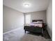 Cozy bedroom with a comfortable bed, natural light, and soft gray carpet at 7536 Shasta Dr, Indianapolis, IN 46217
