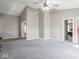 Open bedroom boasts vaulted ceiling, ceiling fan, and access to other rooms at 7536 Shasta Dr, Indianapolis, IN 46217