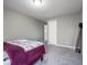 Bedroom with neutral walls and carpet plus a glimpse into another room at 7536 Shasta Dr, Indianapolis, IN 46217