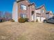 View of the home's front yard, featuring manicured bushes, a brick facade, and an attached garage at 7536 Shasta Dr, Indianapolis, IN 46217