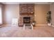 Living room showcasing the charming brick fireplace, a focal point for cozy gatherings and relaxation at 7536 Shasta Dr, Indianapolis, IN 46217