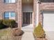 The home's entry includes a sidelight window, a covered porch, and manicured shrubbery at 7536 Shasta Dr, Indianapolis, IN 46217