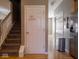 View of the light-filled hallway with hardwood floors and access to rooms and staircase at 7536 Shasta Dr, Indianapolis, IN 46217