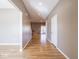 Long hallway with hardwood flooring, neutral paint, and access to other rooms in the house at 7536 Shasta Dr, Indianapolis, IN 46217